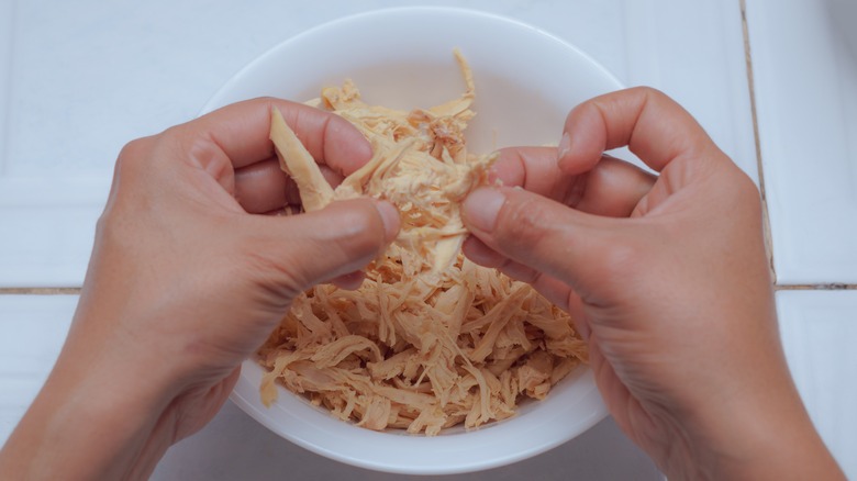 mains déchiquetant la viande